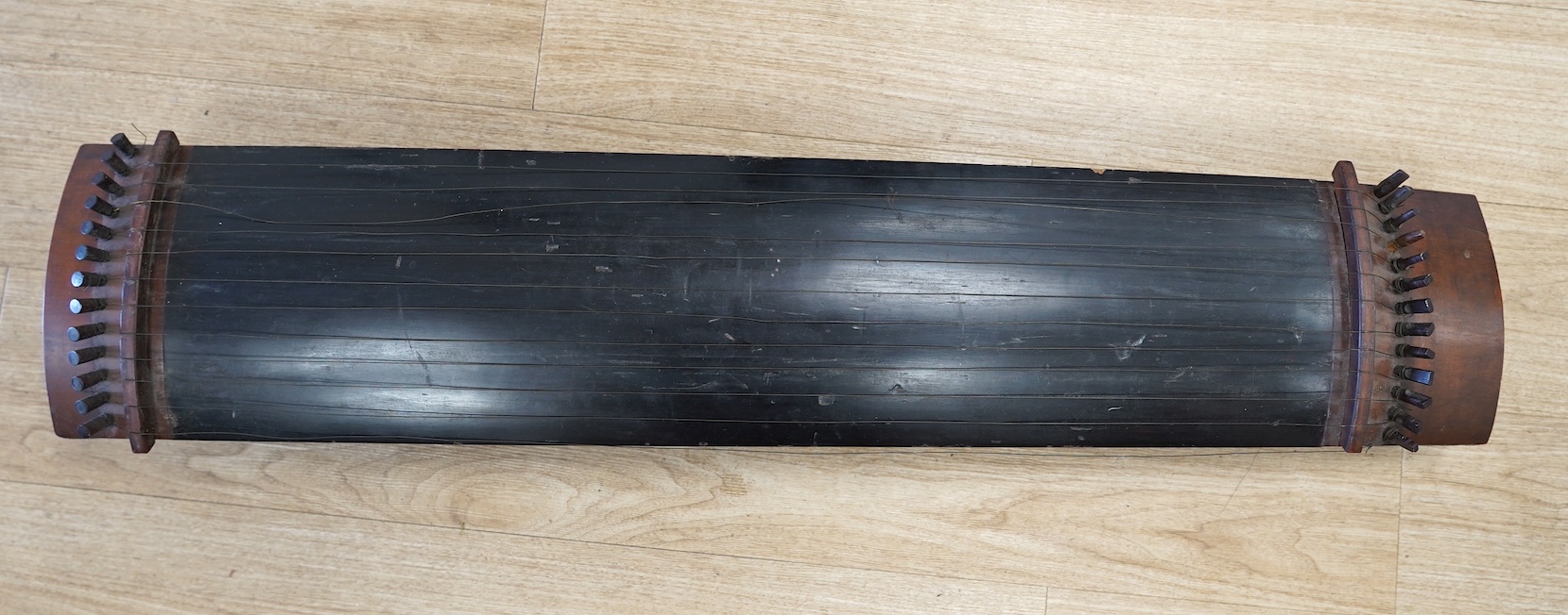 A Japanese Kato musical instrument with spares,19th century, 110cm long. Condition - fair, body of instrument and pegs have damage